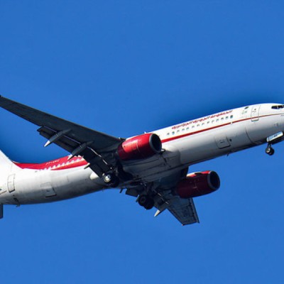 The man survived the flight by riding the plane's landing gear